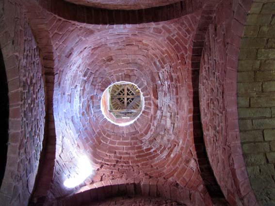 Dans l'église de Collonges la Rouge, un surprenant orifice circulaire placé au sommet d'une coupole du plafond permet de voir l'intérieur du clocher et sa charpente.