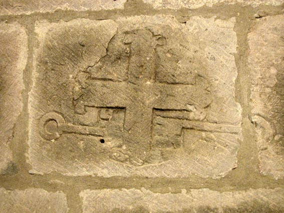 Croix et clés gravées sur le mur intérieur de l'église.